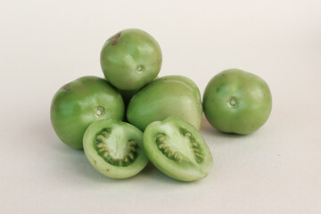 Close up of fresh green tomatoes on isolated background.