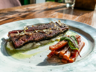 A Gourmet Dish featuring Grilled Protein accompanied by Vibrant and Colorful Vegetables