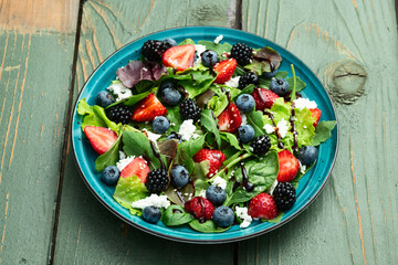 Berries salad (blueberry strawberry blackberry ) with cheese feta and balsamic sauce