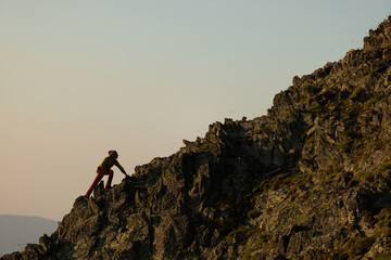 A person is climbing a rocky mountain
