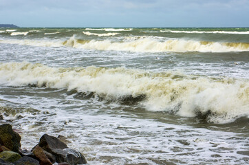 Tides and storms at sea. Seacoast. Waves on the Baltic Sea. Deserted seashore.