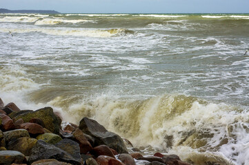 Tides and storms at sea. Seacoast. Waves on the Baltic Sea. Deserted seashore.