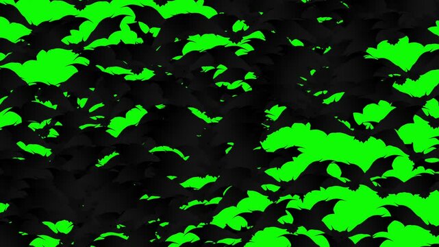A large swarm of Halloween bats flying and filling the green screen