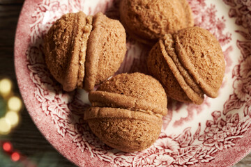 Nut shaped homemade cocoa Christmas cookies filled with cream, close up