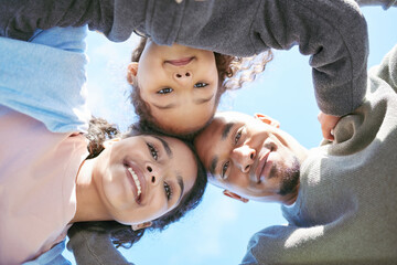 Portrait, happy family and hug bellow outdoor for care, love or bonding on vacation, holiday and...