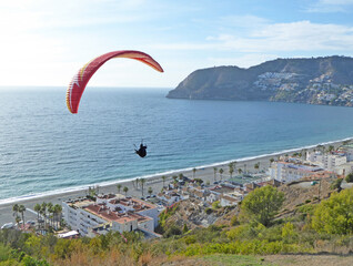 Paragliding above La Herradura beach in Andalucia, Spain	