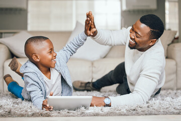 Black family, child and tablet with high five at house for streaming, education success and celebration of learning. Father, boy and digital for reading ebook, study achievement and bonding support