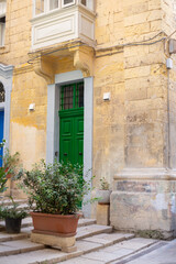 Green bright door on a beautiful street in Valletta, Malta