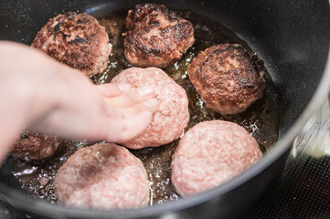 Cooking cutlets. Homemade cutlets are fried in a cauldron.