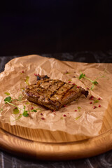 Indulge in a Delicious Grilled Steak Artfully Presented on a Wooden Serving Board