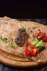 Indulge in a Delicious Grilled Steak Artfully Presented on a Wooden Serving Board