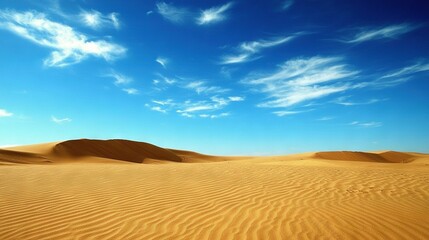   A panoramic view of endless sand dunes bathed in blue skies and surrounded by thin, wispy clouds