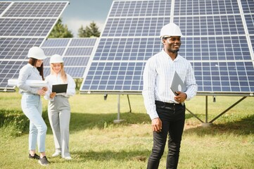 African american technician check the maintenance of the solar panels. Black man engineer at solar station