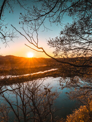 A peaceful autumn sunset over a lake in the forest. A feeling of coziness, calm, happiness, freedom...