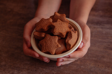 close up of hands holding gingerbreads