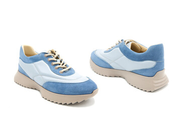 Sneakers. Pair of fashionable leather with suede inserts shoes isolated on white background. View from all sides.	