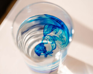 abstract closeup image of methylene blue in a glass of water.