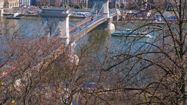 Transportation on secheni bridge. A view of public transportation on chained bridge over Danube river to Budapest famous places in the sun. A concept of places to visit in Hungary during holidays.