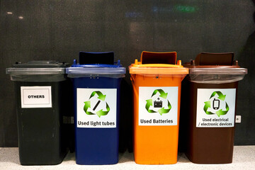 Multi-colored bins for environmentally friendly waste sorting inside the building.