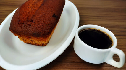 Cinnamon cake, and cup of coffee on the wooden table
