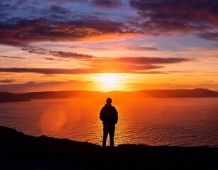 A lone figure silhouetted against a vibrant sunset, contemplating the horizon.