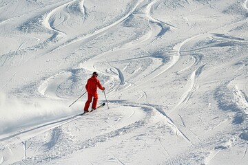 A person skiing down a snow-covered mountain slope