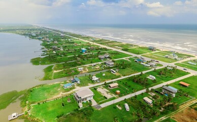 Holiday homes along the coast on the  Bolivar Peninsula, in the Gulf of Mexico, Texas, United States. © Zenstratus