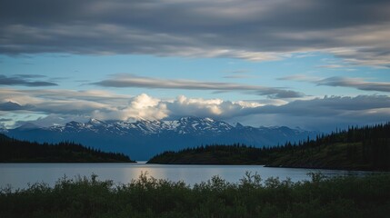 A Breathtaking View of a Calm Lake Amidst Mountain Peaks