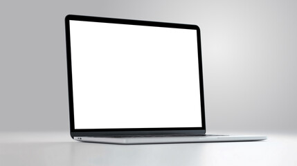 A sleek laptop is open and idle on a smooth surface, showcasing a blank screen in a well-lit environment