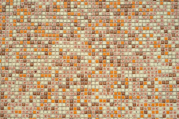 Residential building wall with small mosaics looking like green and brown pixels.