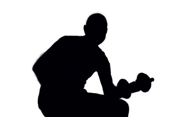 Silhouette of a middle aged man lifting exercise weights. 