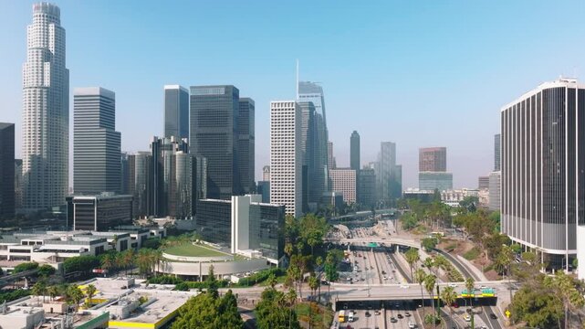 Downtown Los Angeles is a bustling metropolis in California known for its modern cityscape with skyscrapers, highways, and parks against clear skies, making it a vibrant urban area in the USA