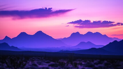 Fototapeta premium Purple and pink sunset over mountain range