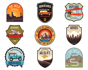 Set of vintage camping badges featuring various wilderness-themed designs including mountains, forests, and outdoor activities. Stock travel labels