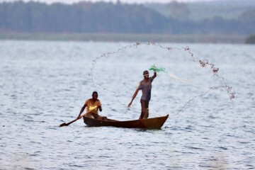 African Net Fisherman from canoe on Lake Victoria 
