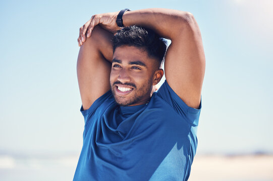 Man, thinking and stretching arms by beach for warm up, daily workout routine and fitness for muscle development. Male person, happy and flexing for physical cardio, training or exercise for health.