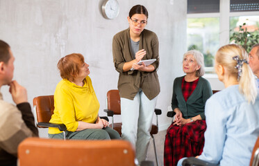 Young woman doing group training for seniors people