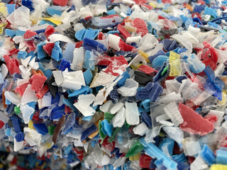 Closeup image of colorful plastic flakes. Concept pollution, environment, save the planet. PP plastic recycling from bottles. Bottle cap. PET bottle recycled. High quality photo