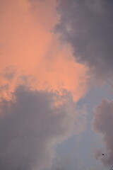 A pink cloud peeks through the blue clouds