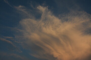 Yellow evening clouds in blue sky, background