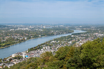 Panoramic view of the Rhine River and surrounding cityscape from Drachenfels, showcasing the region's urban and natural landscapes.
