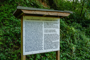 Informational sign about the volcanic history of the Siebengebirge mountains, explaining its...