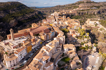 Naklejka premium Picturesque view from drone of historic district of Cuenca city on steep spur above deep gorges of Jucar and Huecar rivers on sunny spring day, Spain