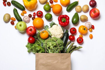 Delivery of vegetarian products. Bag with different vegetables and fruits on white background, top view