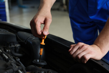 Auto mechanic fixing car at automobile repair shop, closeup