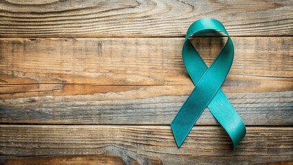 Teal awareness ribbon on wooden background, symbolizing support for ovarian cancer awareness