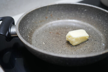 A Piece of Butter Melting Delightfully in a NonStick Frying Pan at the Cooking Station