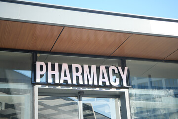 Fototapeta premium A colorful building background with a visible pharmacy sign in the urban street view
