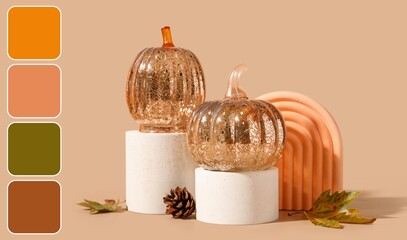 Podiums with decorative pumpkins and autumn leaves on beige background. Different color patterns