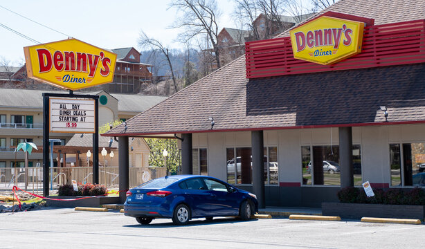 PIGEON FORGE, TN - 12 MAR 2024: Denny&rsquo;s Diner signs and restaurant and parking lot, on a sunny day in Tennessee.
